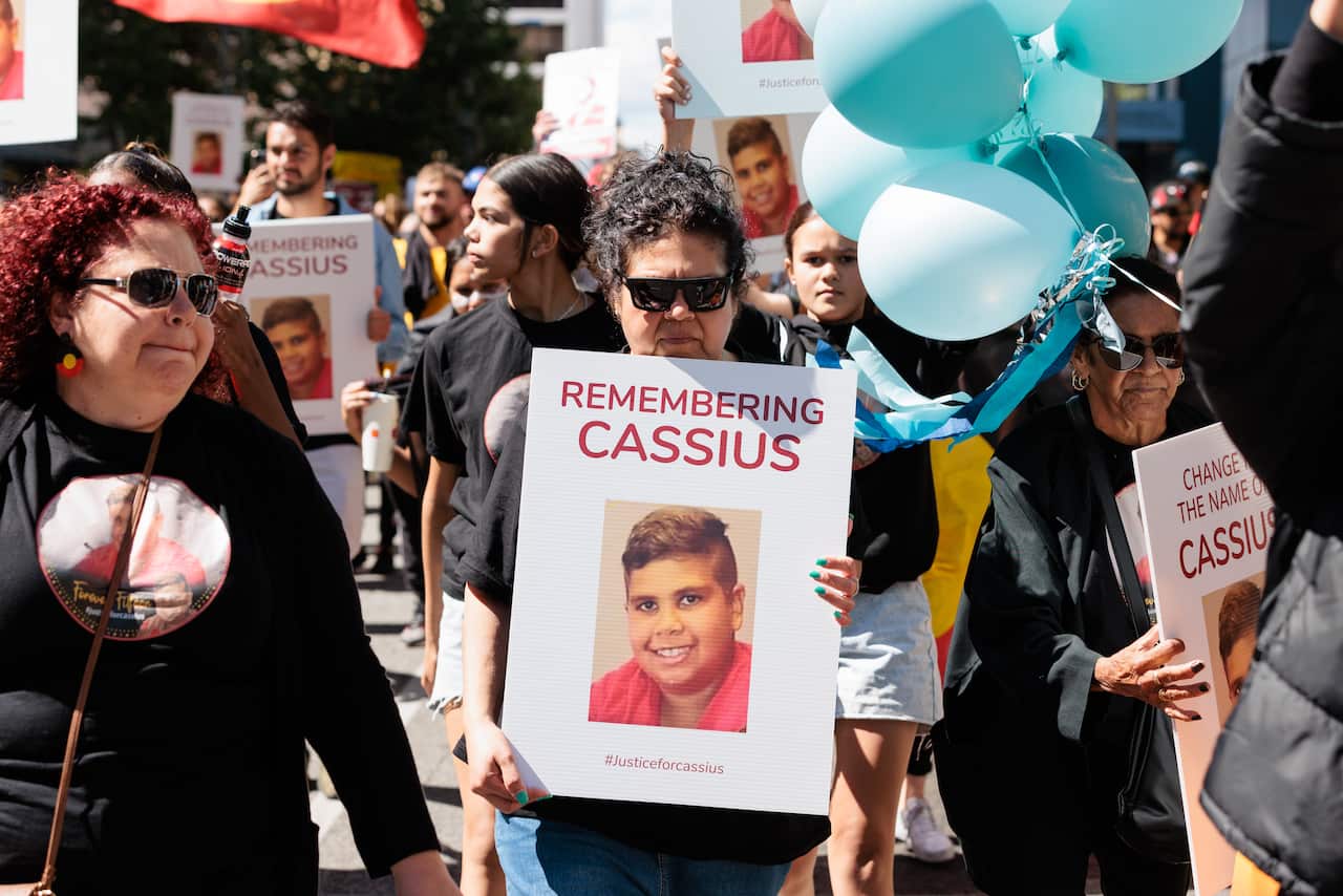 Mechelle Turvey (centre) marches with family, friends and members of the public during a rally