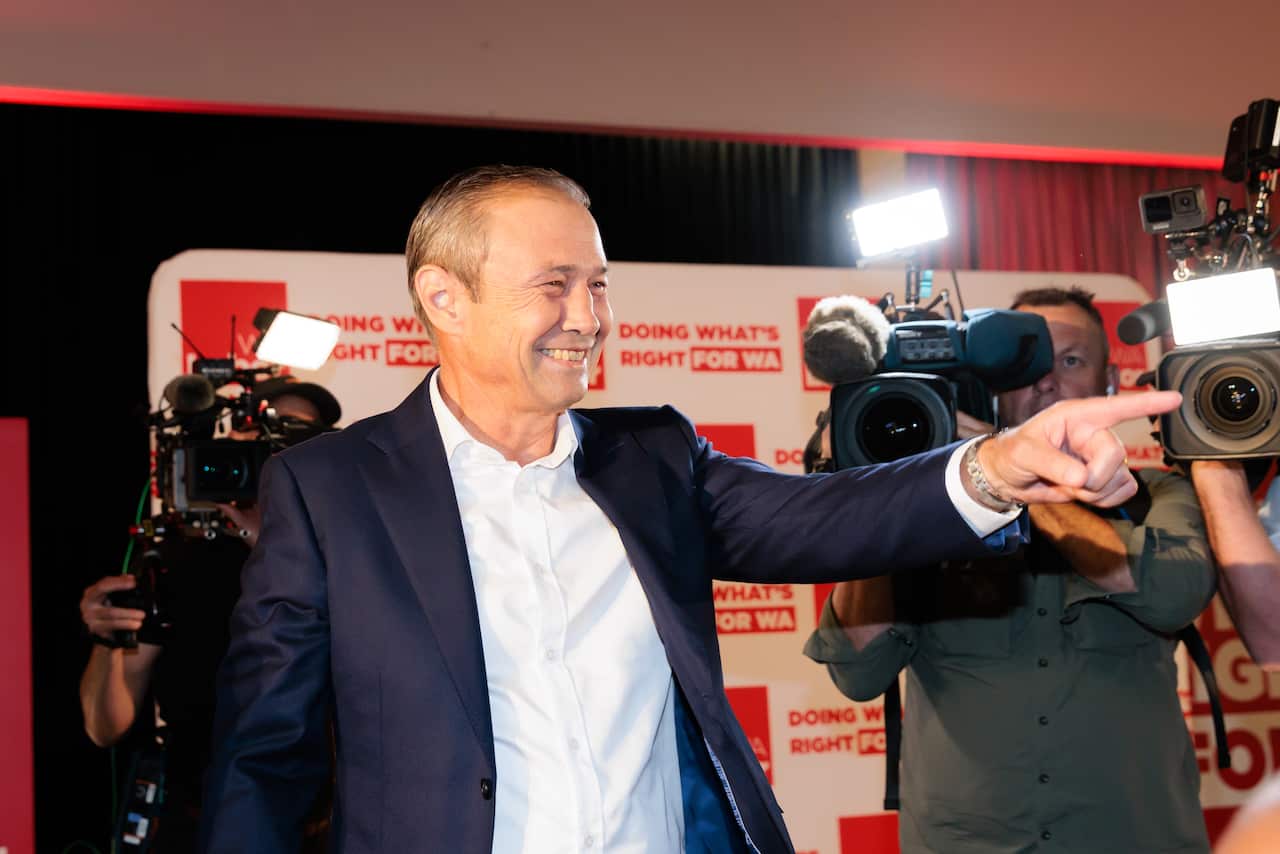 A man smiling and pointing