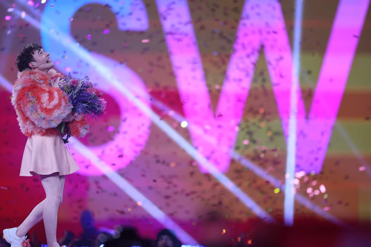 A performer on stage surrounded by confetti