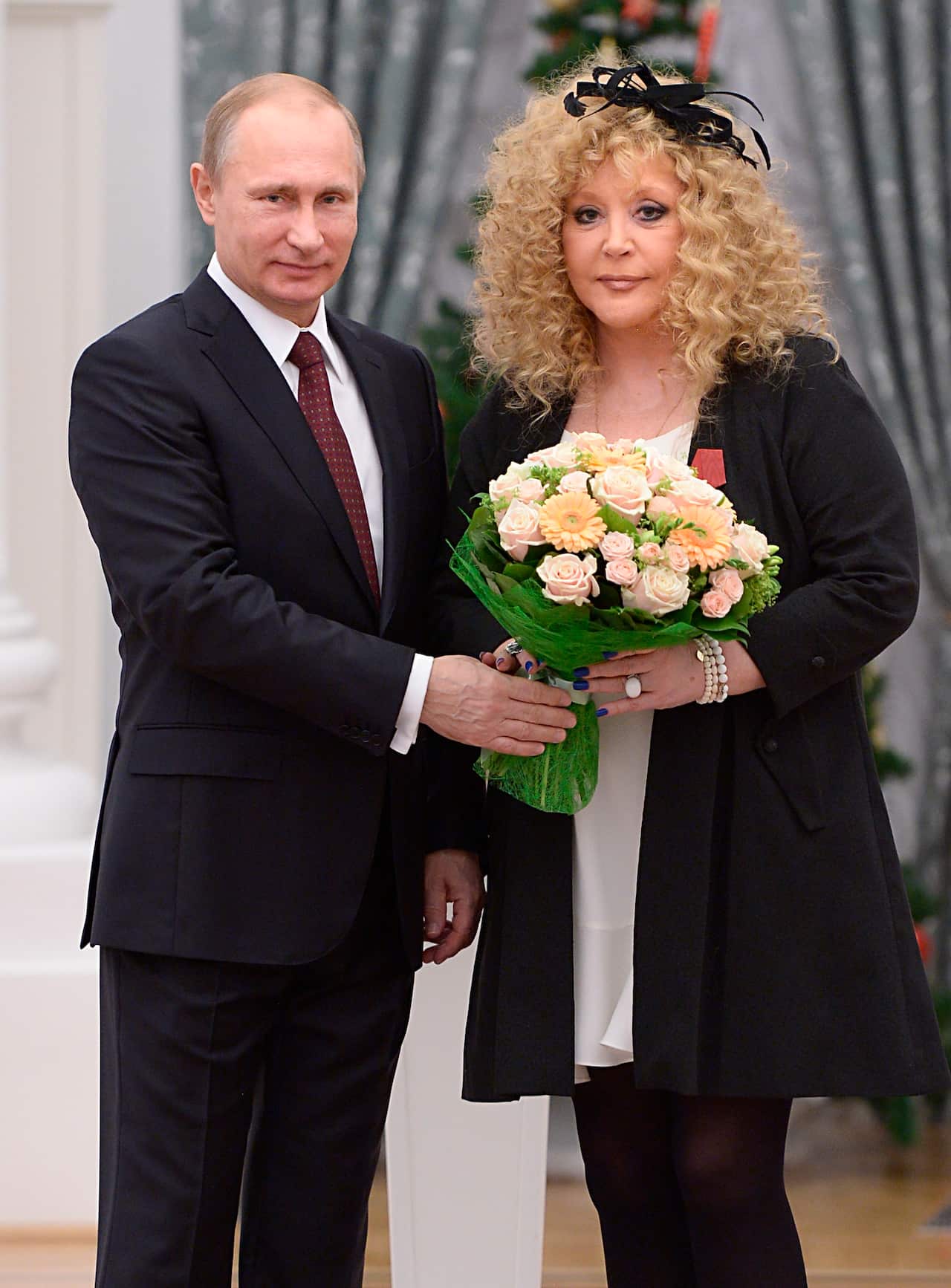 Russian President Vladimir Putin, left, and Russian pop singer Alla Pugacheva pose for a photo during an awards ceremony in Moscow, 2014.