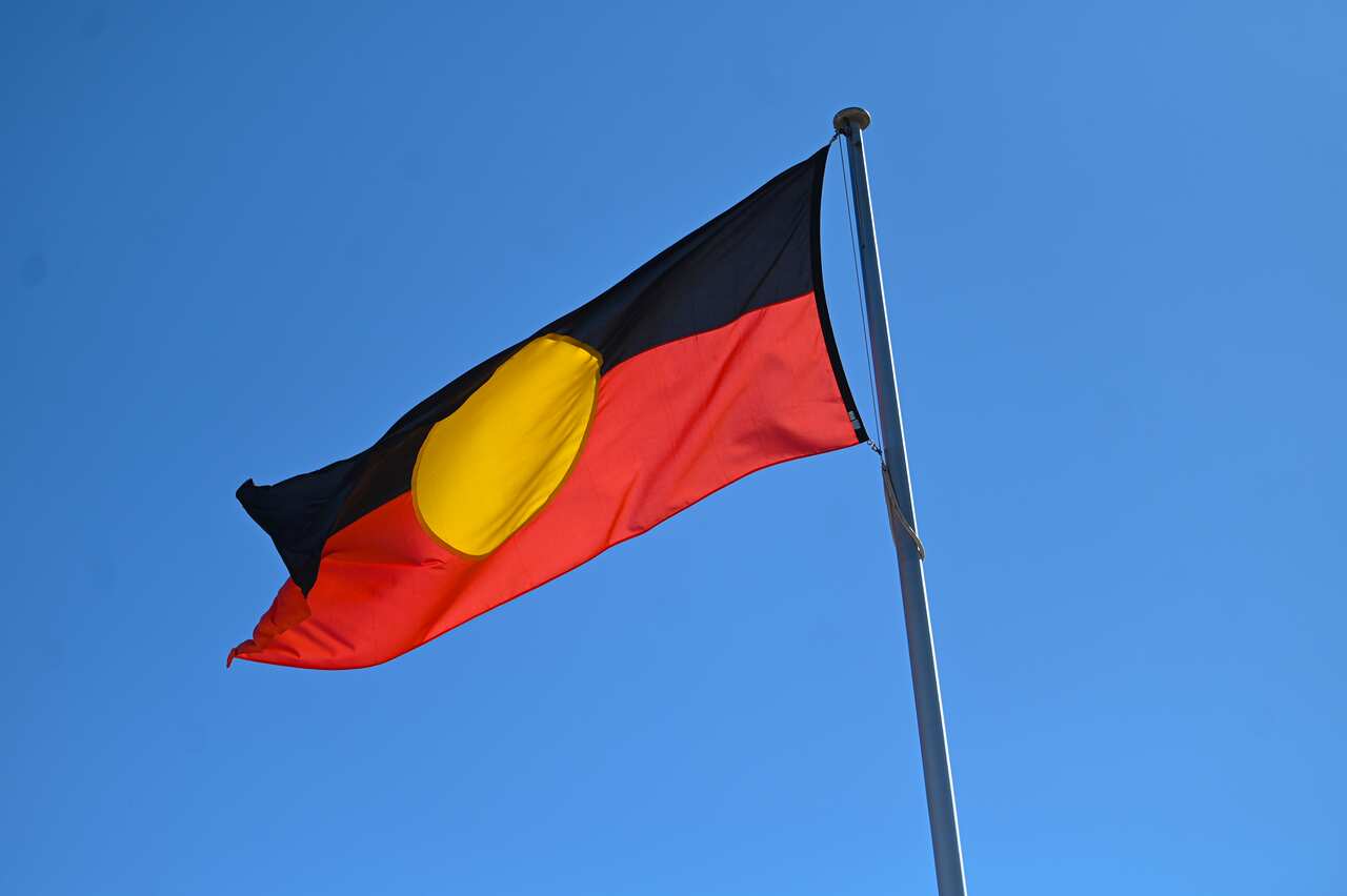 The Aboriginal flag flying from a flag pole.