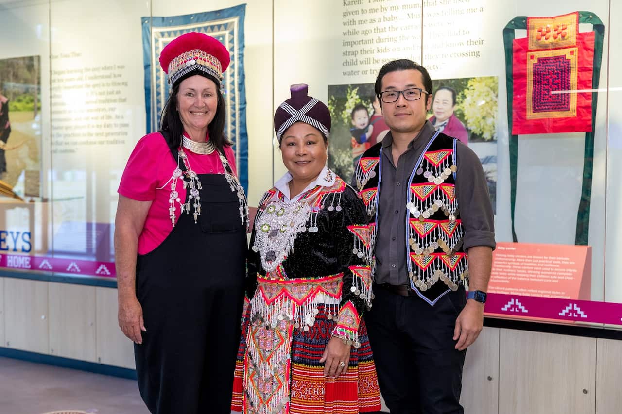 Cr Teresa Lane, Neng Vang and Dr Garry Yang in Hmong traditional clothing at the opening of the new exhibition.jpg