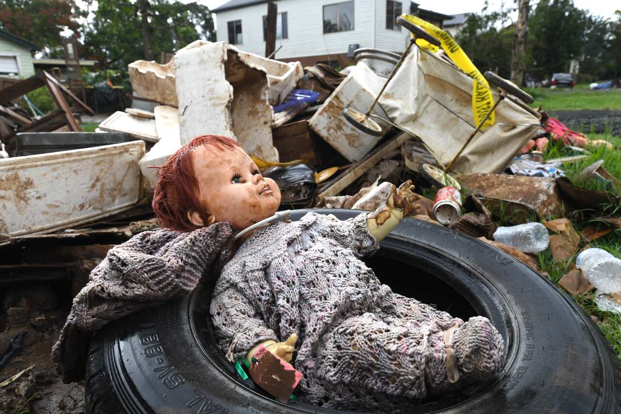 A baby doll among rubbish outside a home in Lismore.