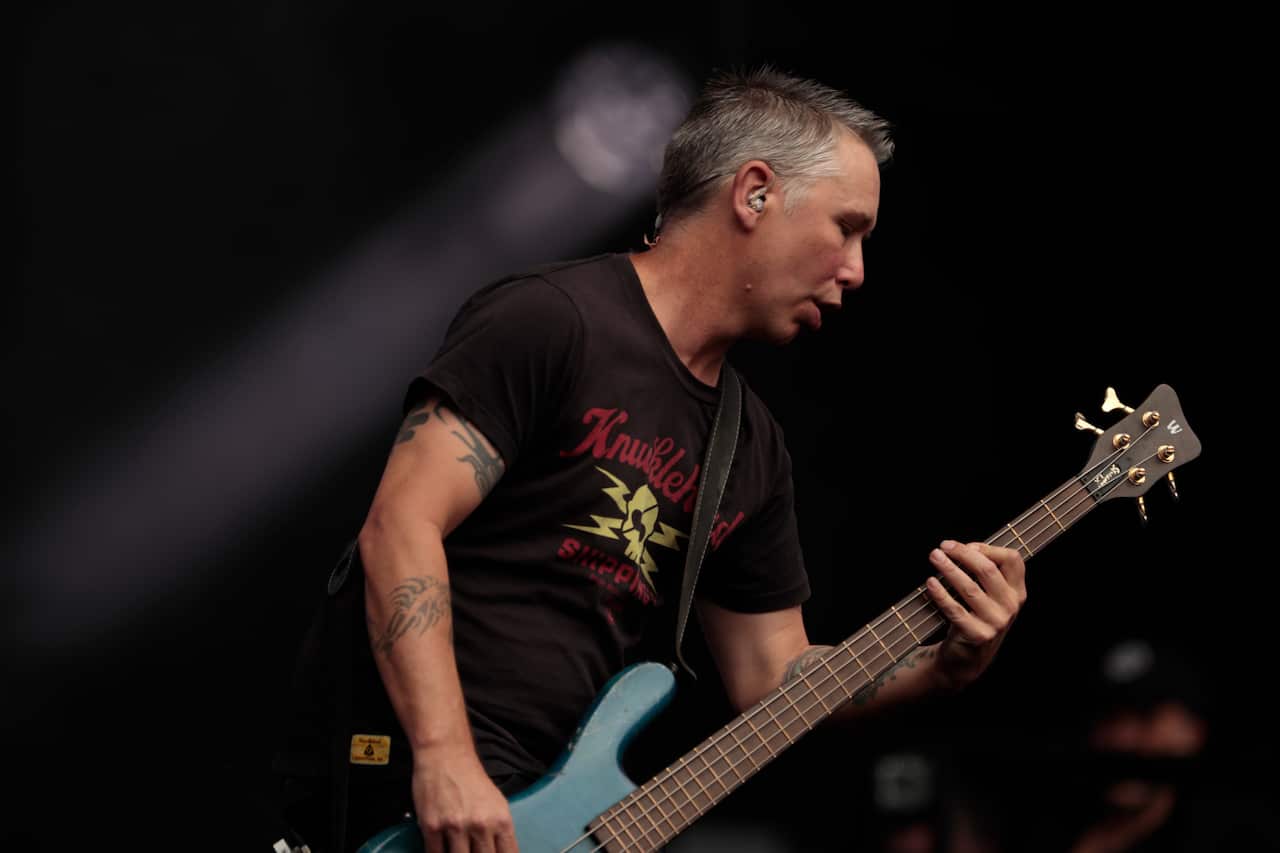 A man playing a bass guitar.