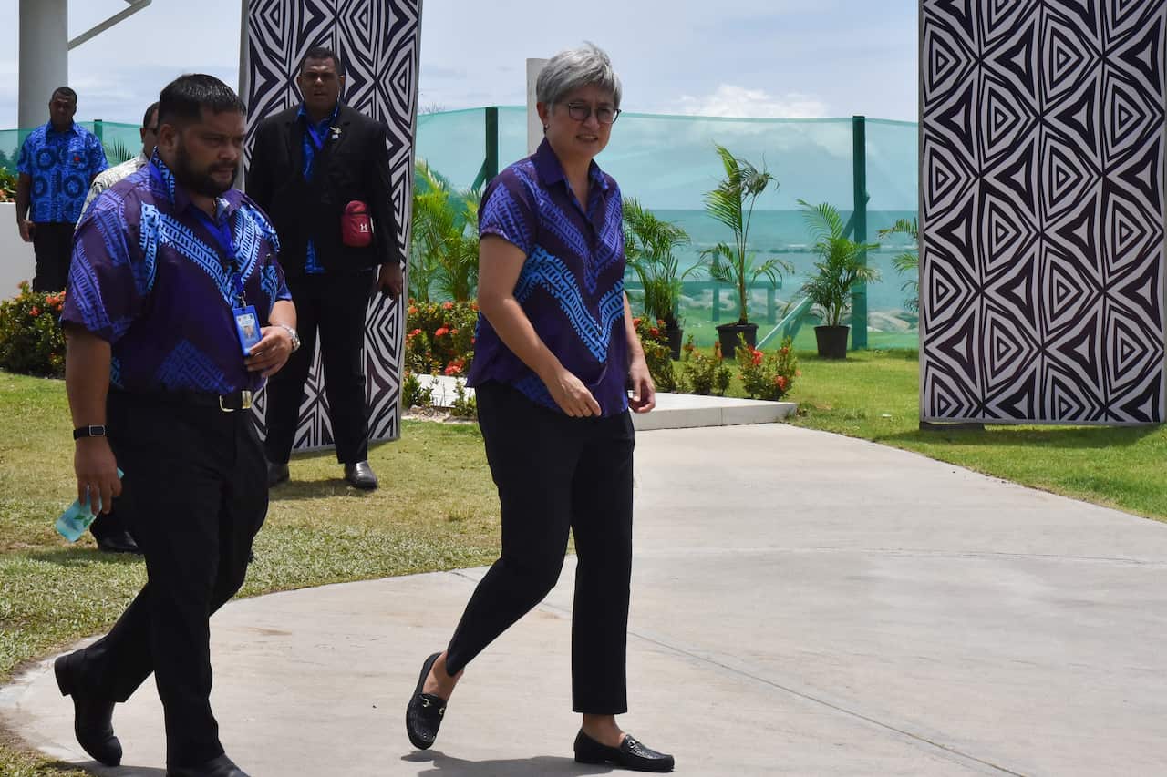 Penny Wong walking outside in Fiji