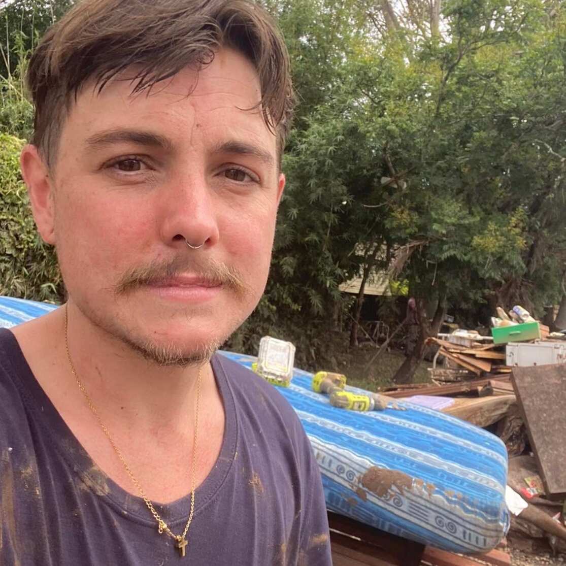 Harper Dalton looking at camera with debris in the background.