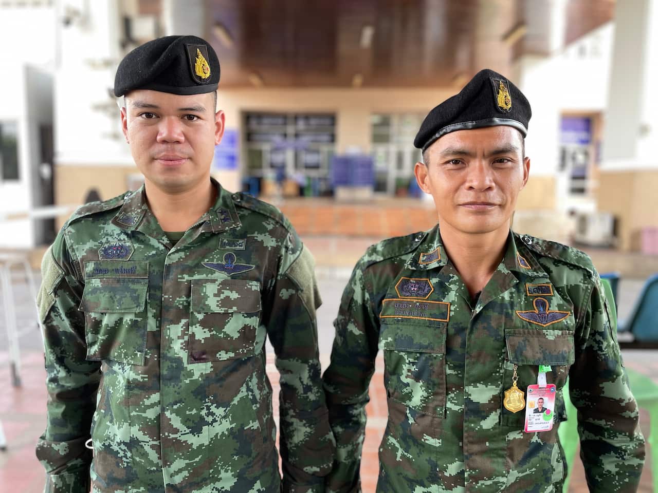 Two men wearing military uniforms.