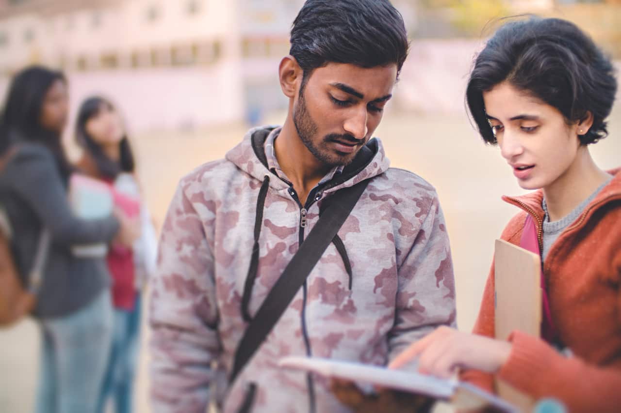 Male and female college student friends together.