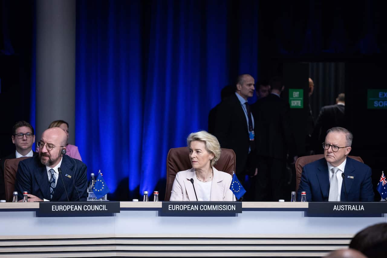 Two men and one woman sit alongside each other.