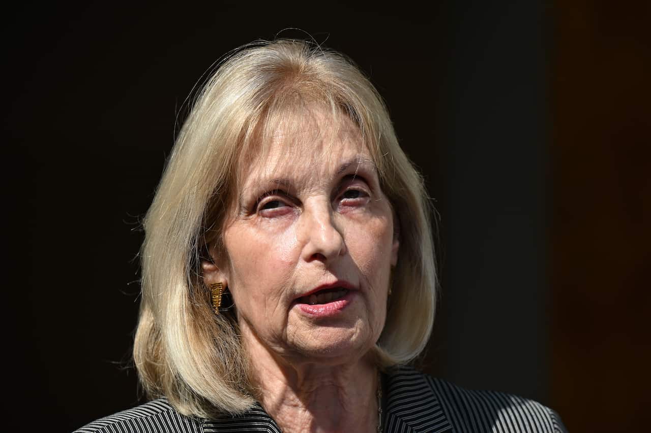 A close-up shot of a woman with a blonde bob