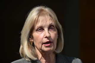 A close-up shot of a woman with a blonde bob