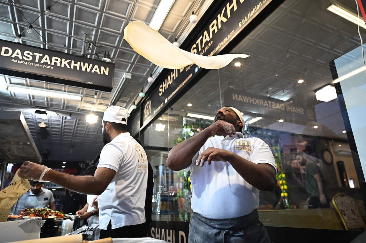 Man throws dough in air. 