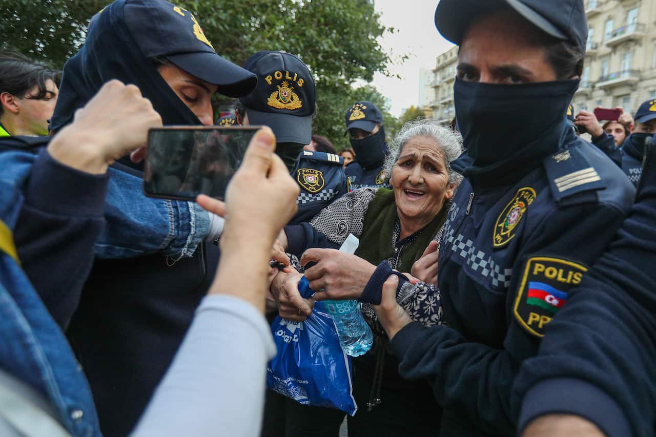 Police arrest elderly woman as crowd films