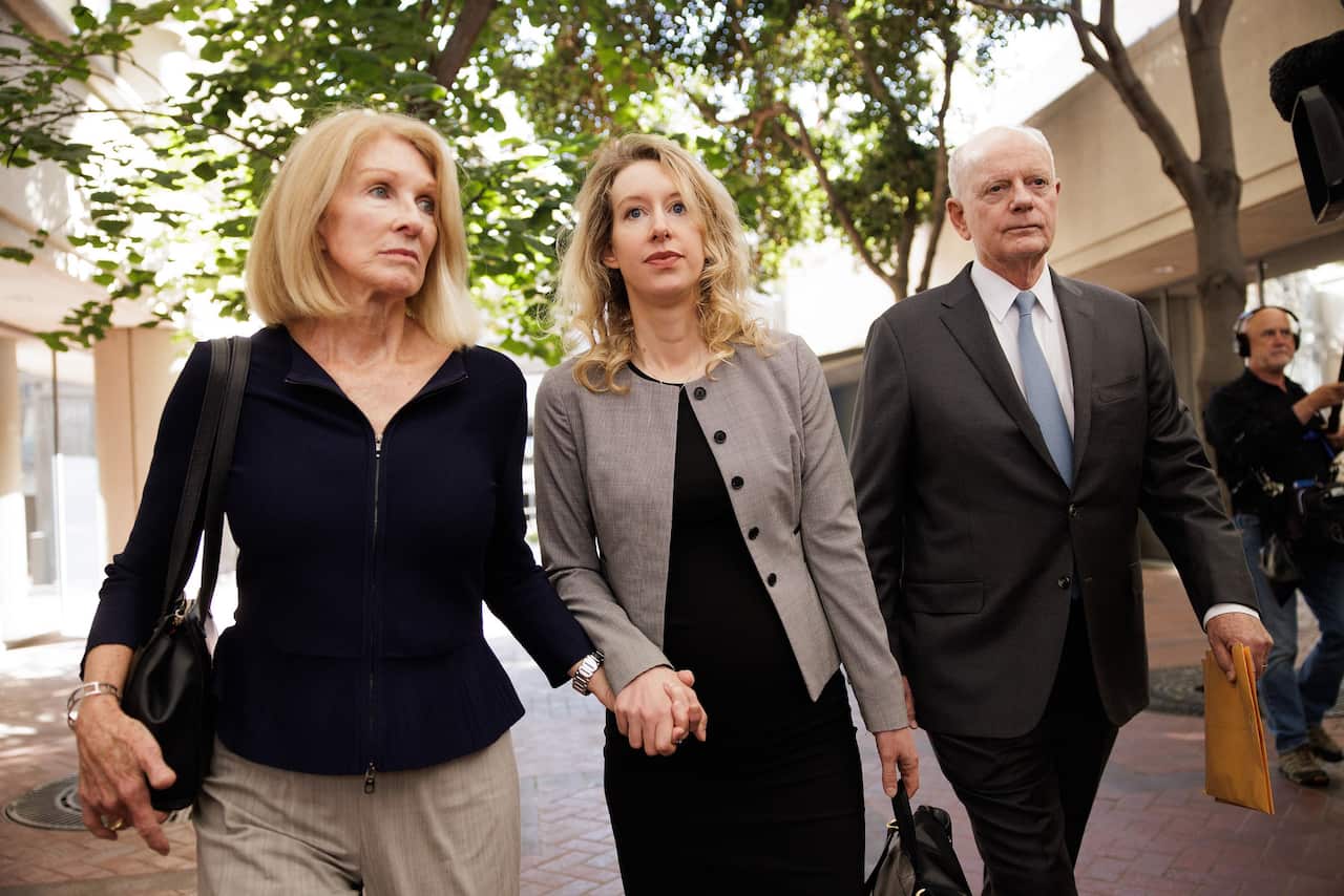 Theranos founder Elizabeth Holmes, (centre) and her parents, Noel Holmes and Christian Holmes, arrive at the Robert F. Peckham Federal Building and US Courthouse in San Jose. 