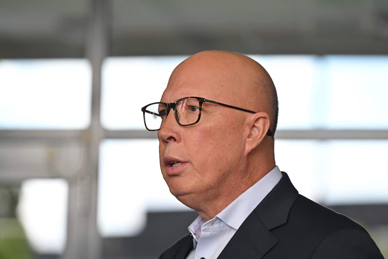 Side profile of a man in a suit and glasses.