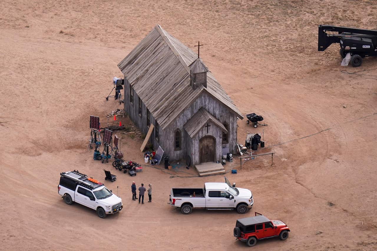 Rust film set shows a church building and camera equipment.