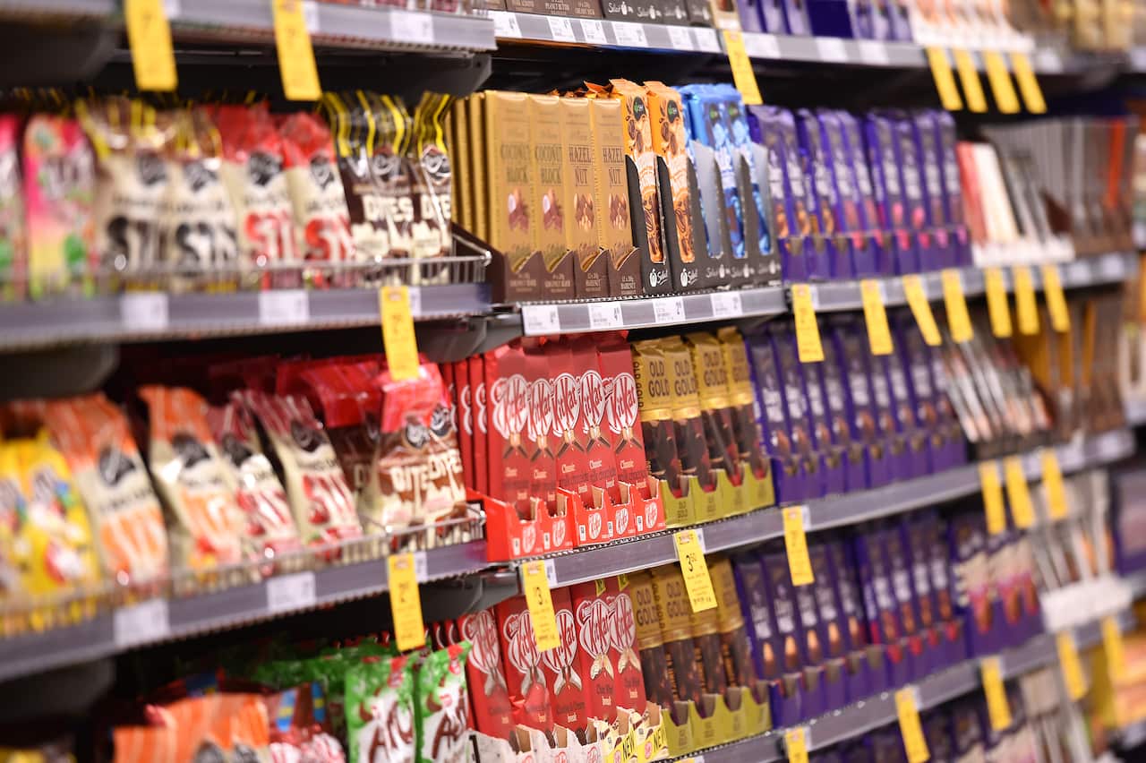 Confectionary aisle with specials labels on shelves