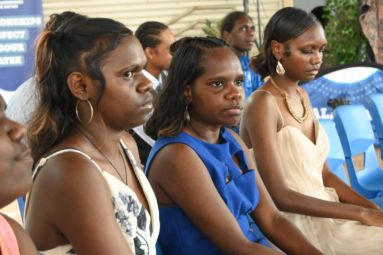Year 12 graduates (L-R) Rosita Badari, Keisha Nagurrgurrba and Elaine Koimala-Brown wait to accept their awards at a ceremony in Gunbalanya