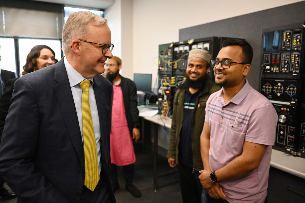 The Australian Prime Minister smiles at university student 