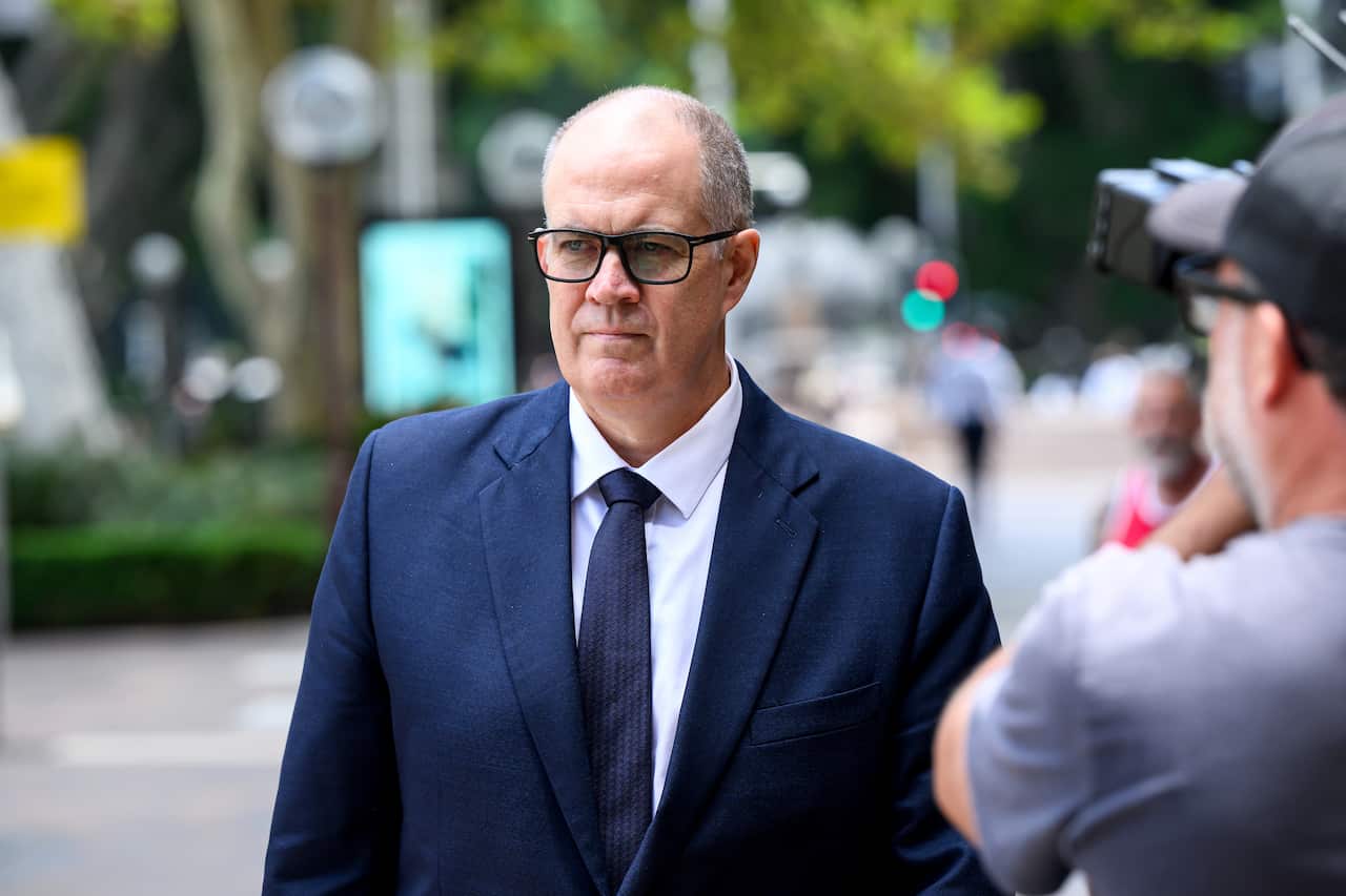 A man wearing a suit while walking down the street.