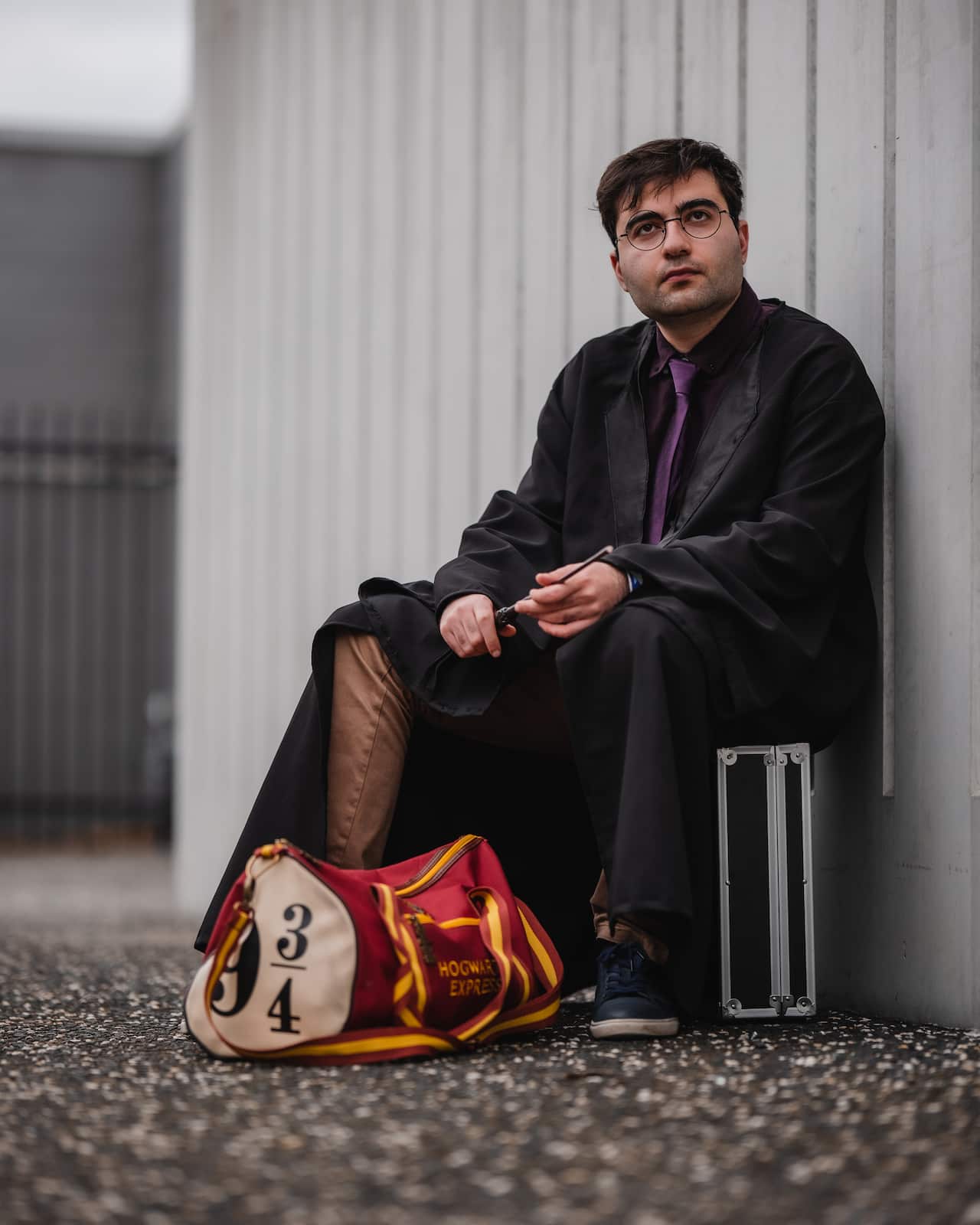 A man in a Harry Potter costume sitting down