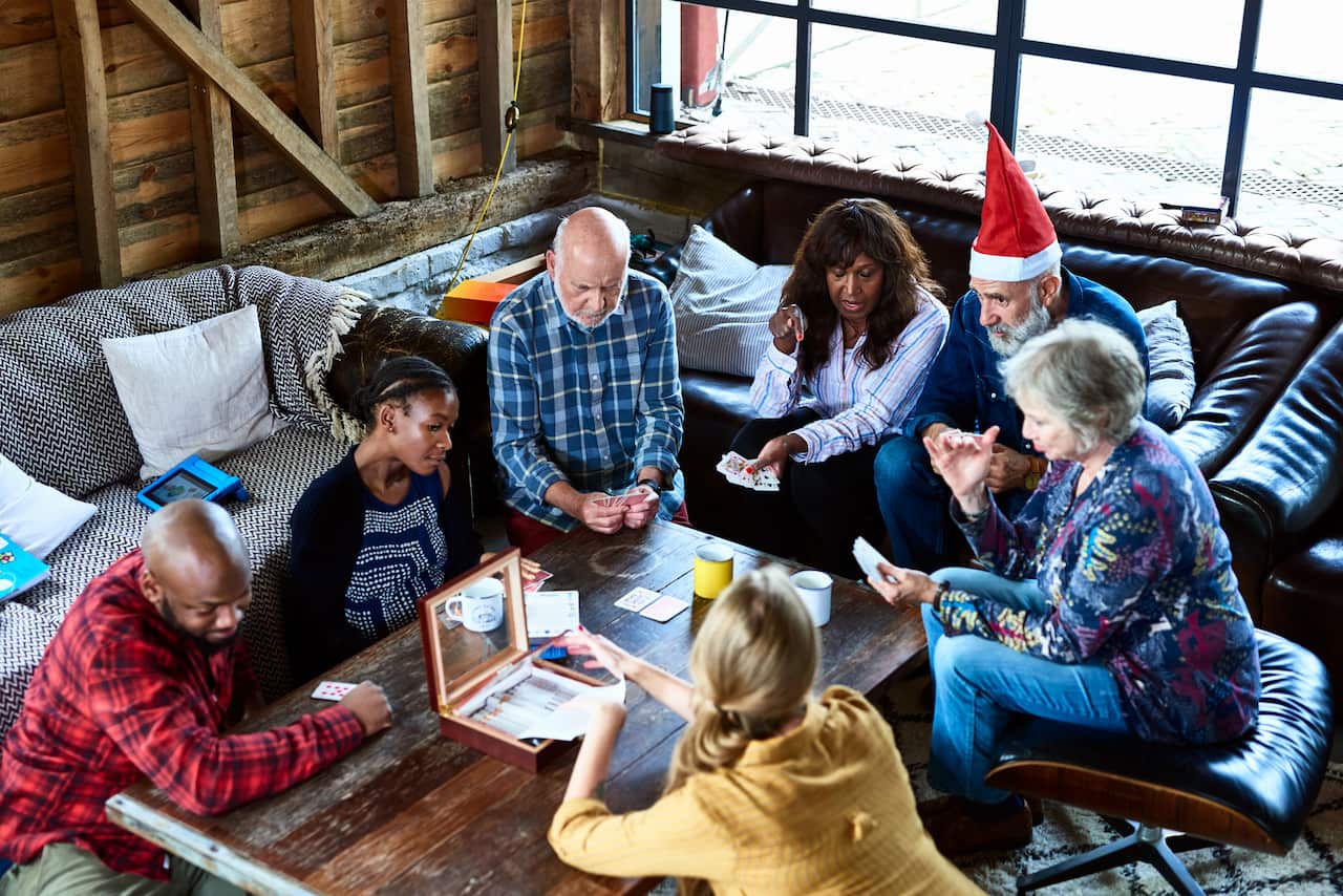 Family playing games on coffee table at Christmas