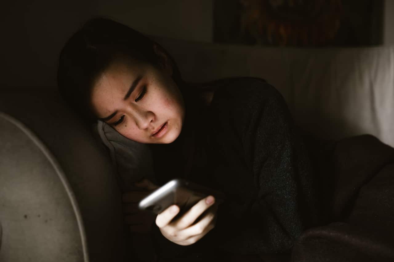 DV-a woman holding her phone in the dark-Pexels-ROENAE Productions.jpg