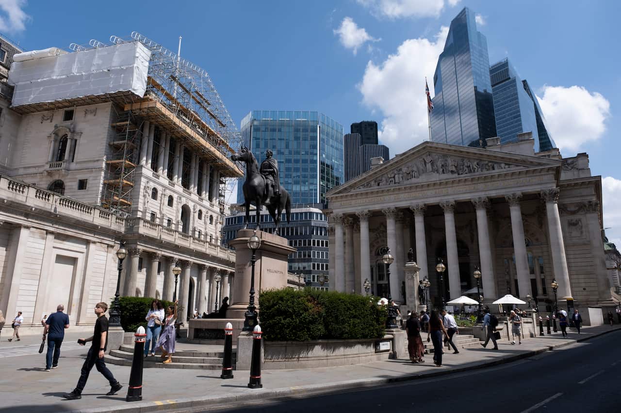 Historic buildings with skyscrapers behind.