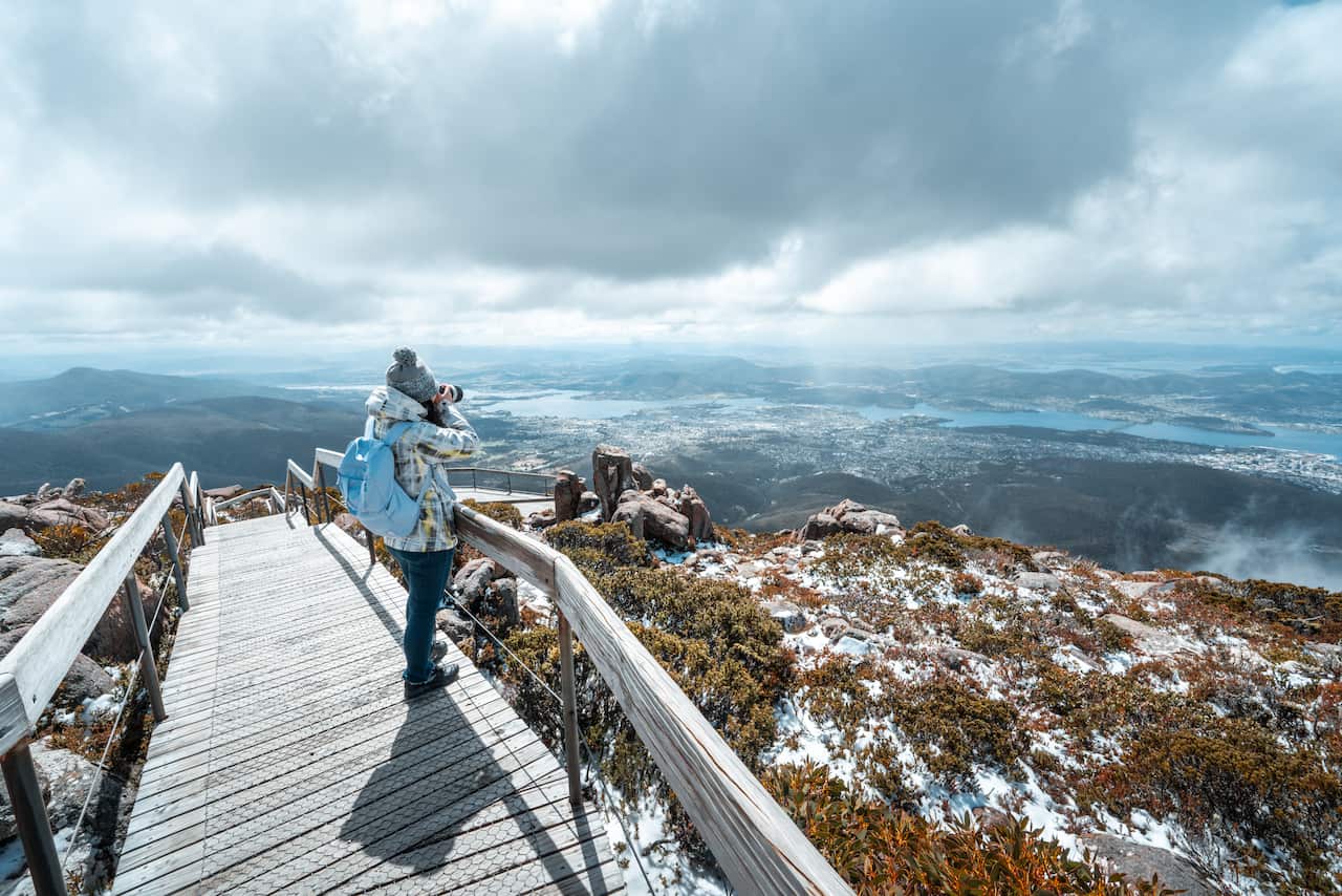 A Female Tourist is Taking Photos with a Digital Camera