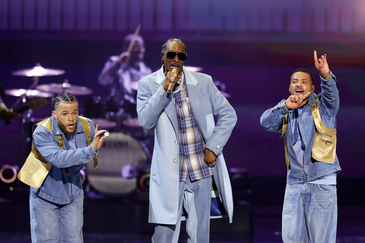 A group of rappers on stage performing