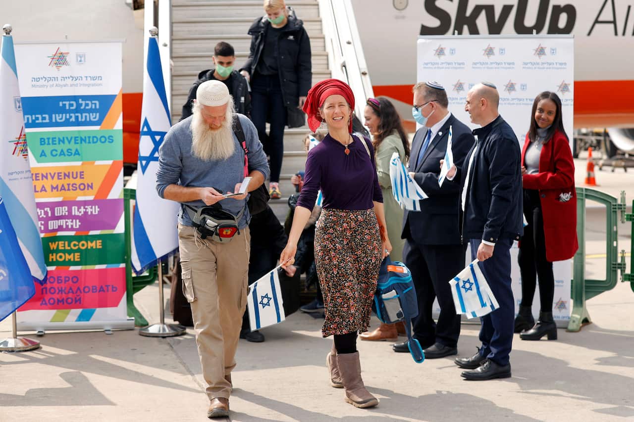 People getting off a plane