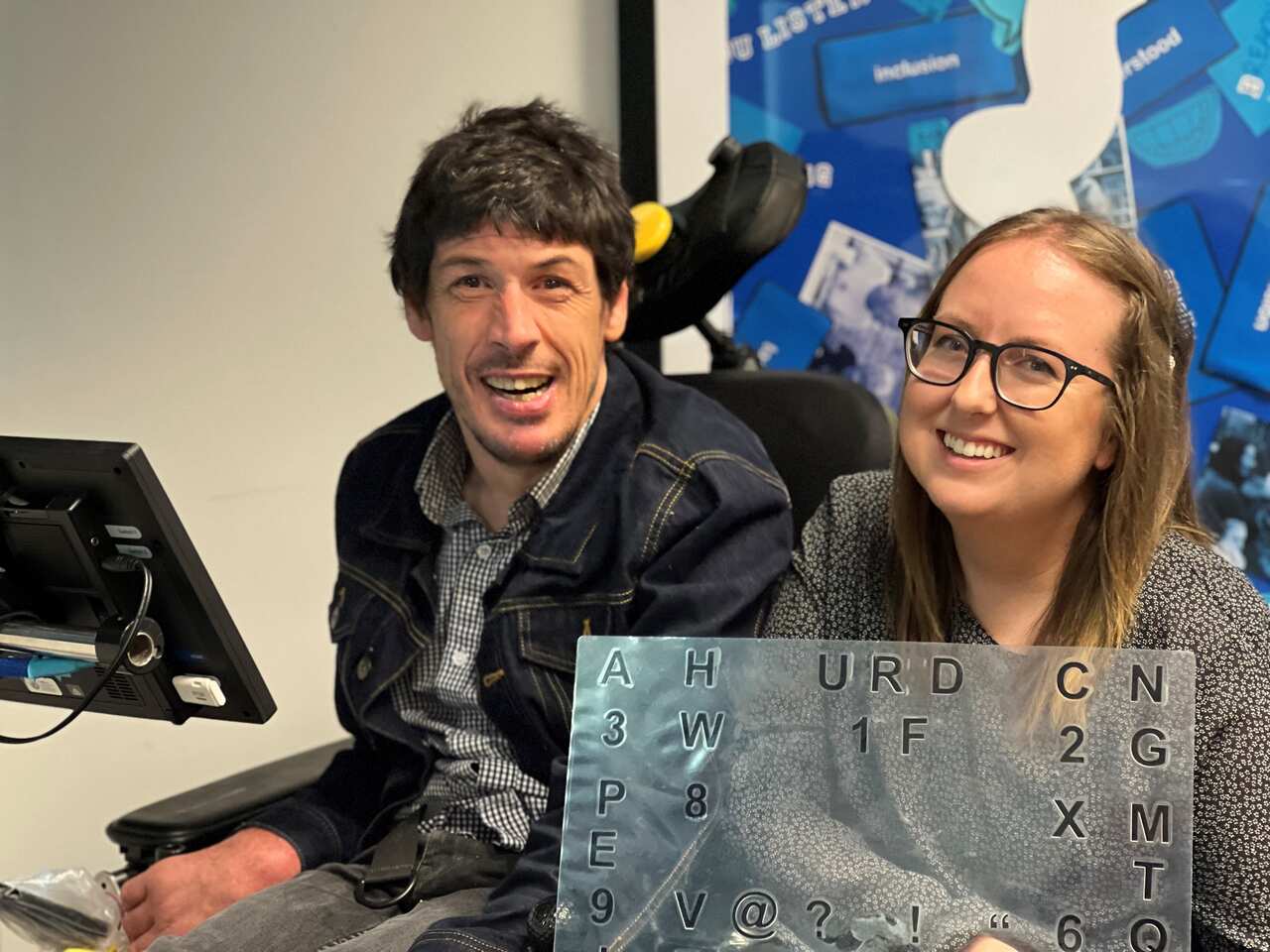 A man and a woman sitting next to each other.