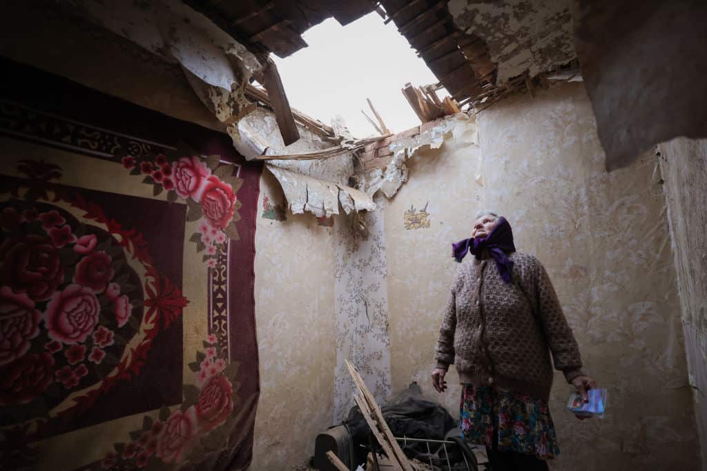 A woman in a house badly damaged by shellfire in Gorlovka, February 24 2022.