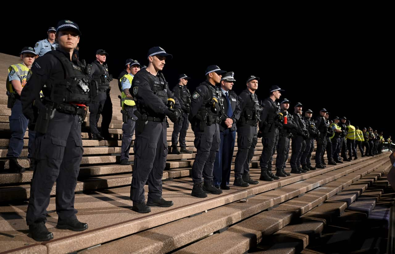 Lines of police standing on the steps of the Sydney Opera House
