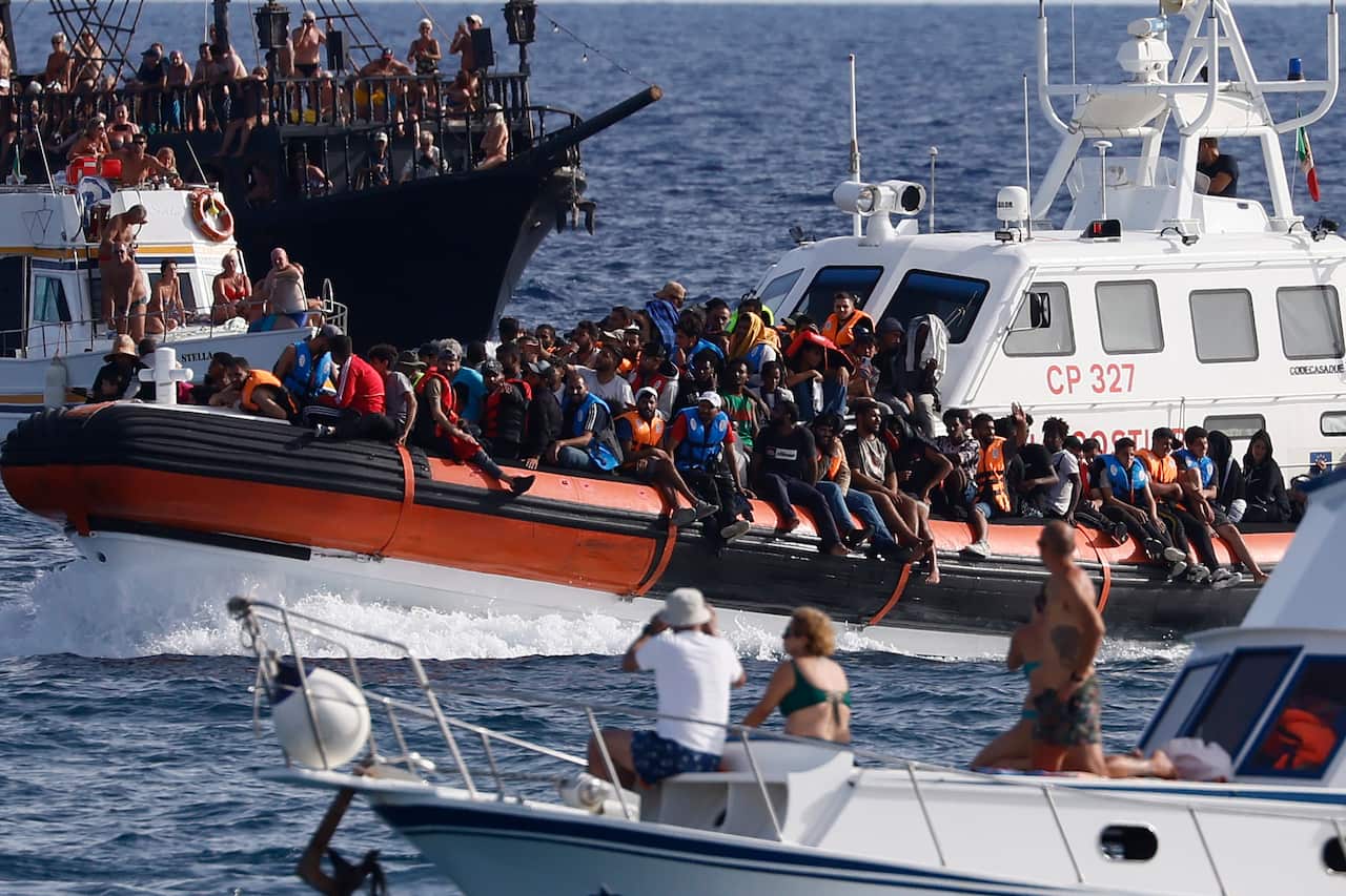 APTOPIX Italy Migration