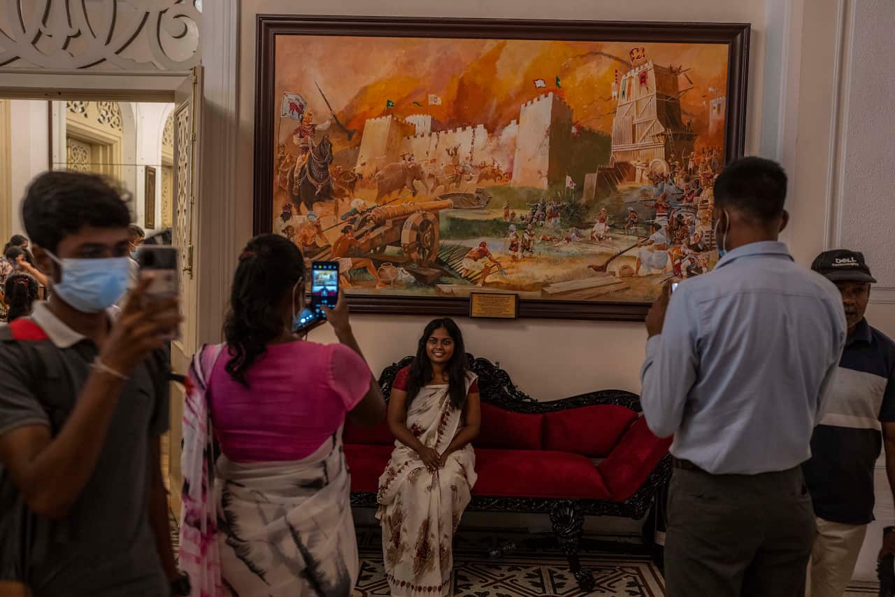 People take pictures at President Gotabaya Rajapaksa's official residence on the second day after it was stormed in Colombo, Sri Lanka.