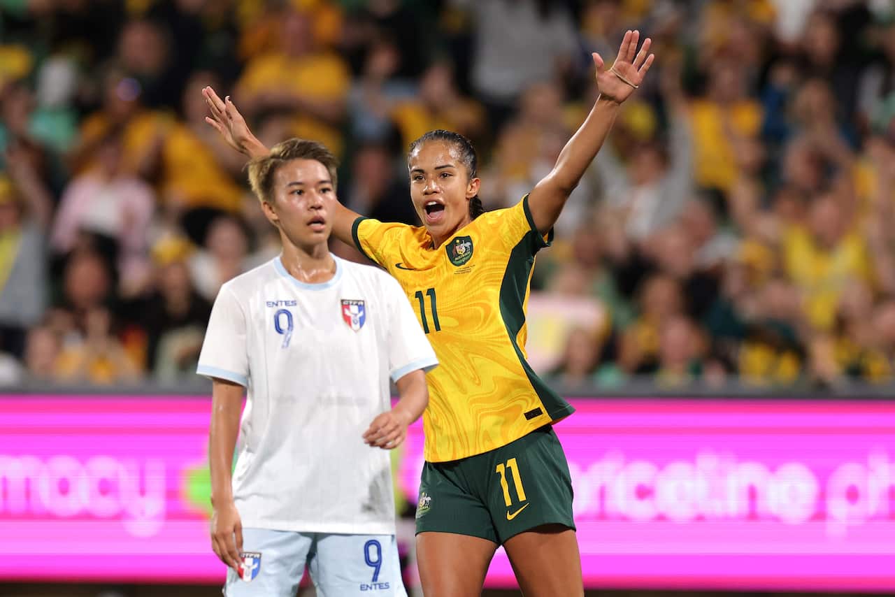 Mary Fowler celebrates after scoring a goal