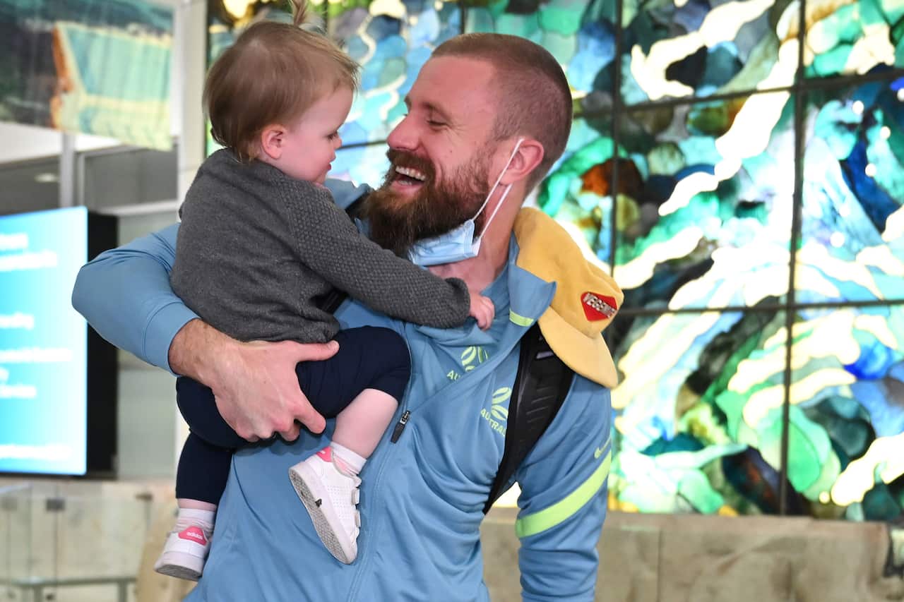 Man holding baby in airport