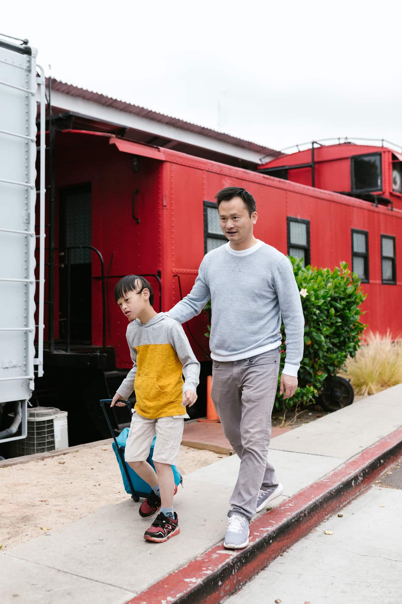 disabled-A father walk with a disabled boy pulling a luggage at a train station-pexels-rdne-stock-project.jpg