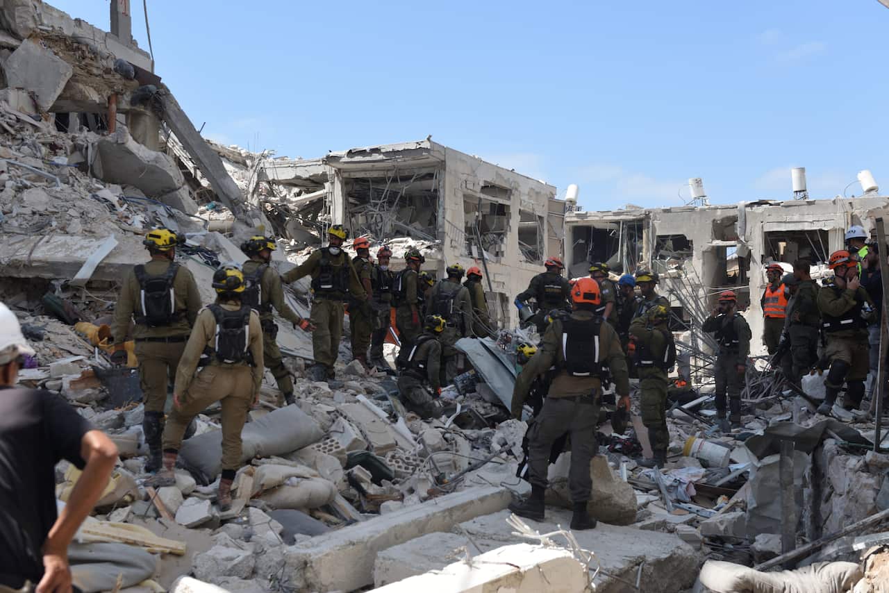 Rescue personnel at a building in Bat Yam, Israel, damaged by ballistic missile shot from Iran