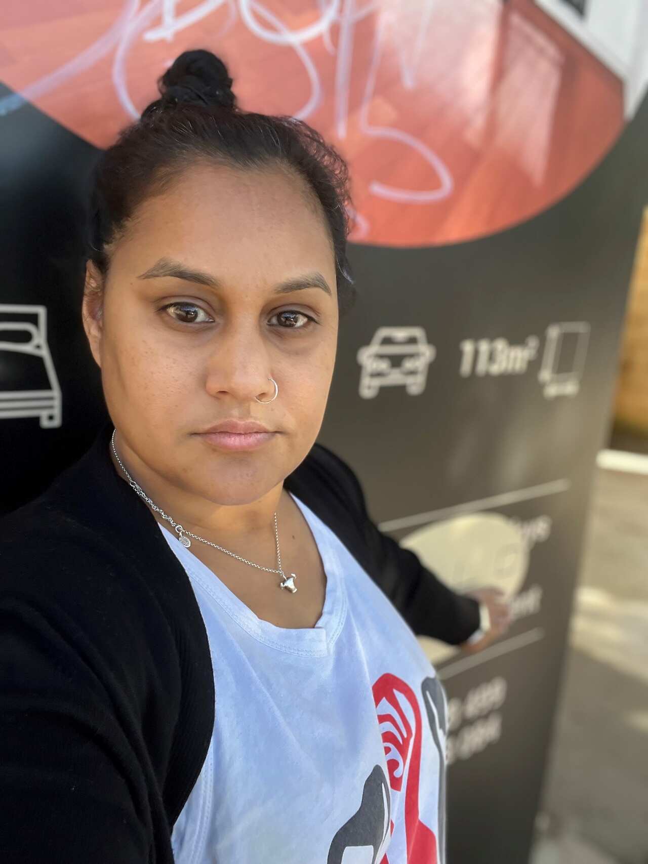 A woman neutral facial expression taking a selfie.