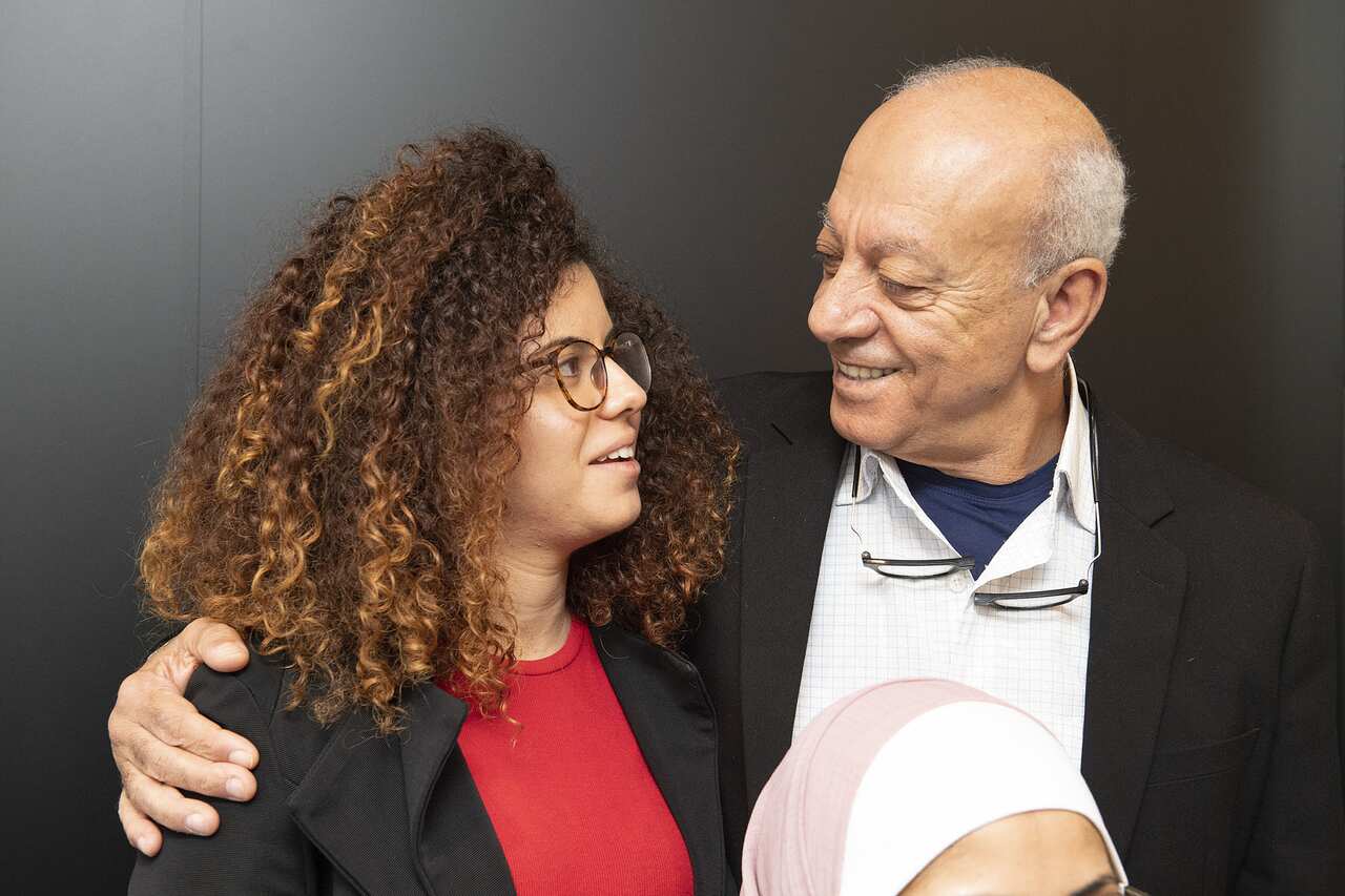 A man with his arm around a woman