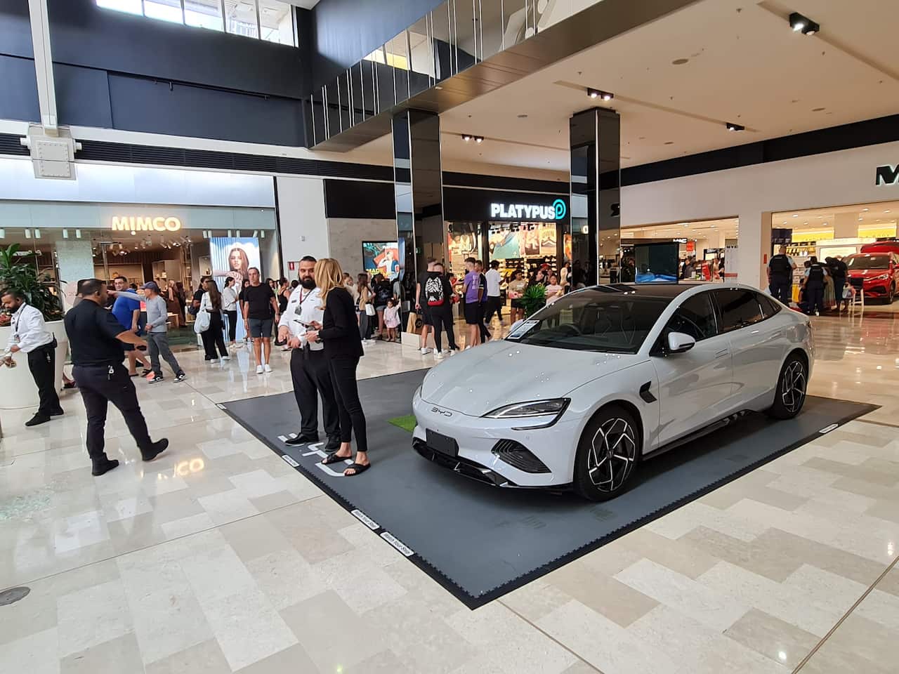 A car parked on display inside a shopping centre.