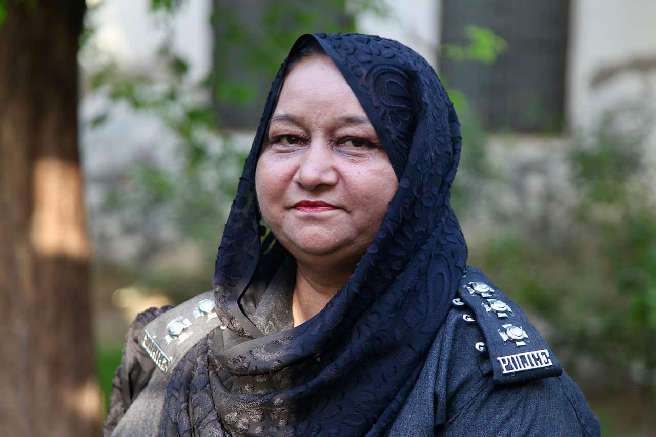 A woman wearing police uniform and a headscarf