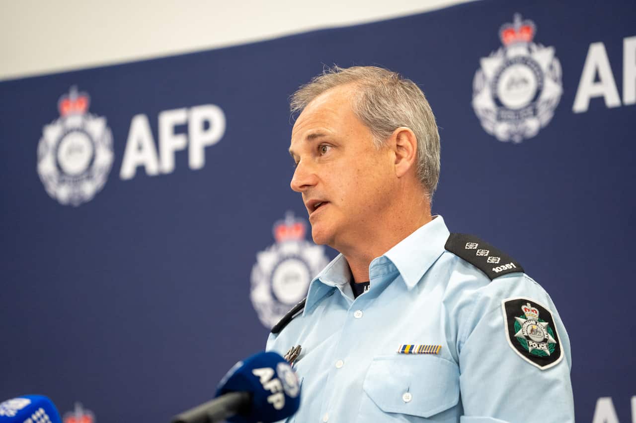 A policeman speaking into a microphone