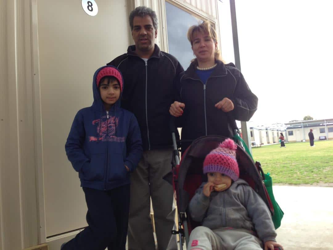 Reza Rostami and his wife and children standing outside