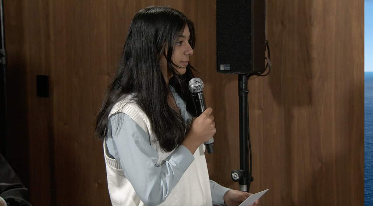 Girl stands with a microphone. 
