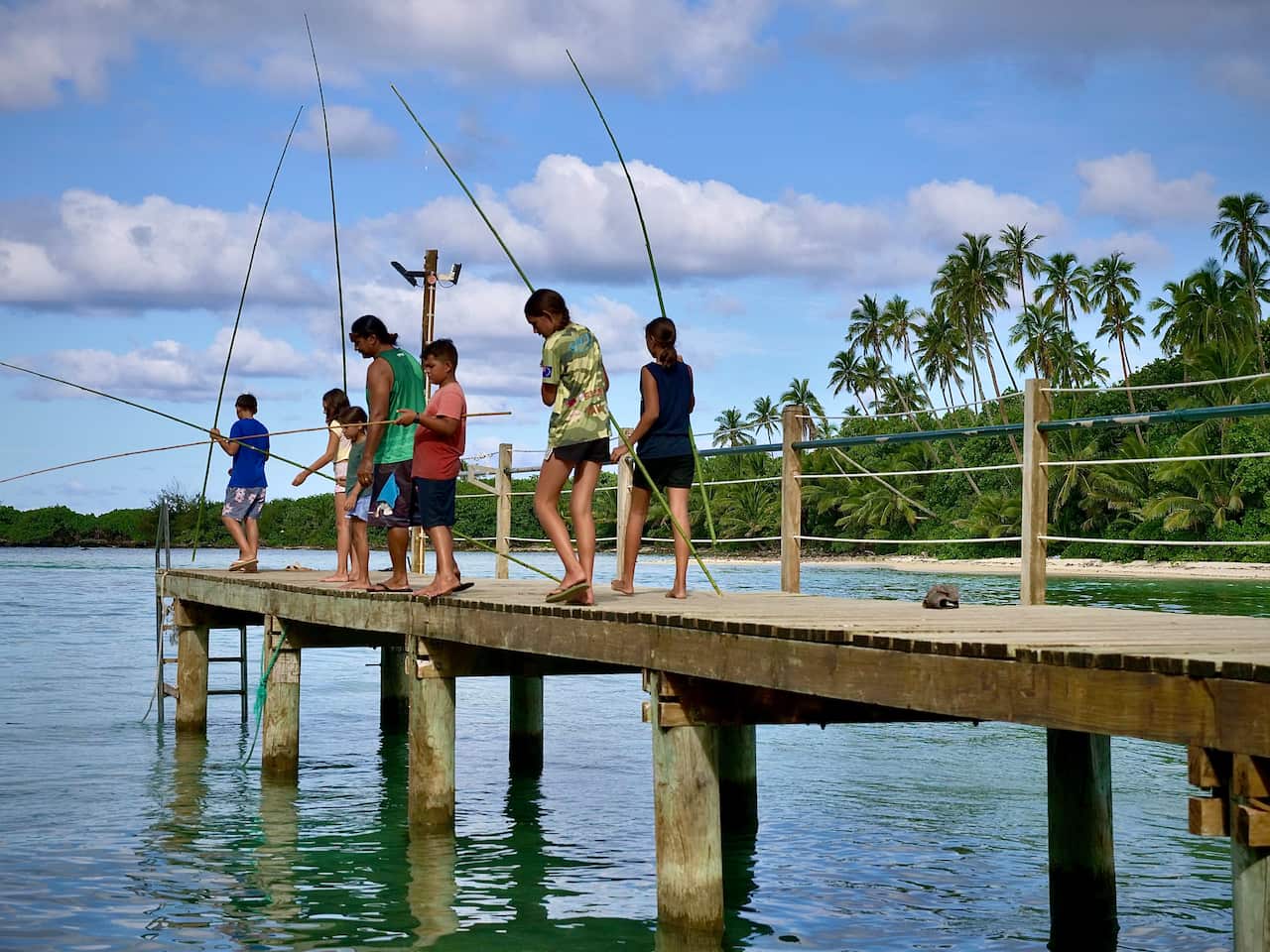 Children fish with traditional poles in Rarotonga. 