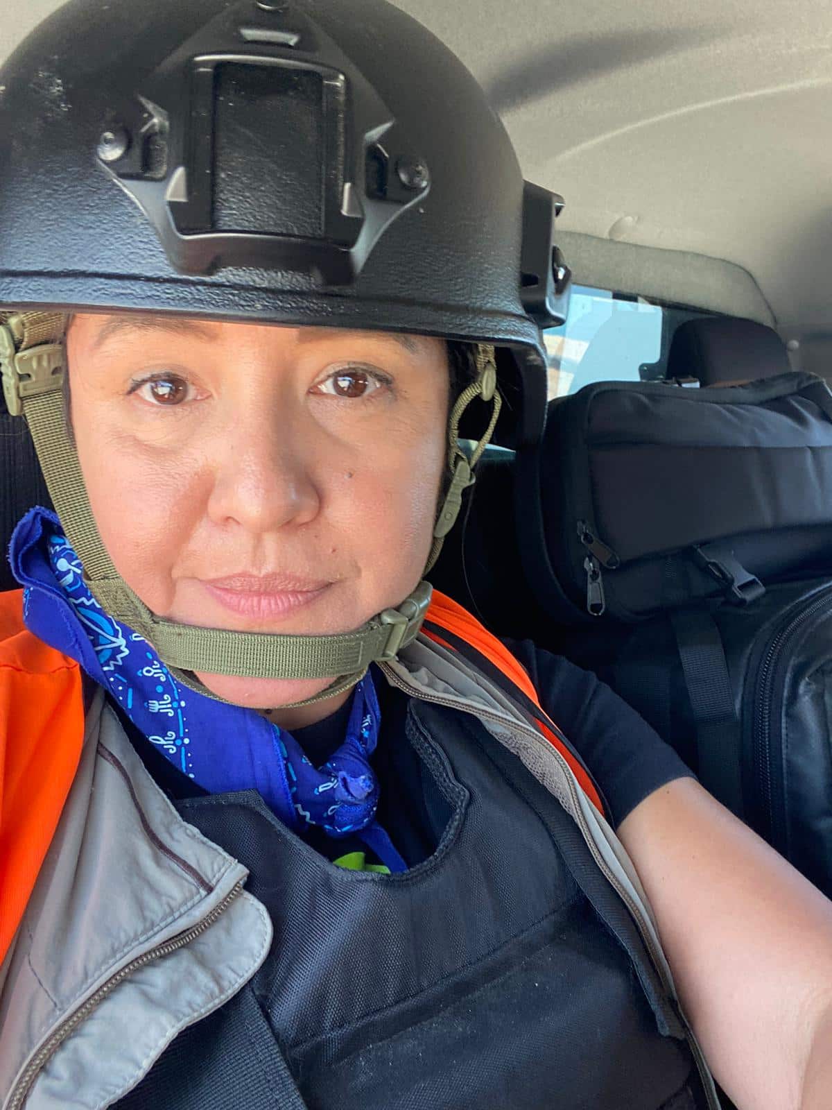 A woman with a helmet in a vehicle