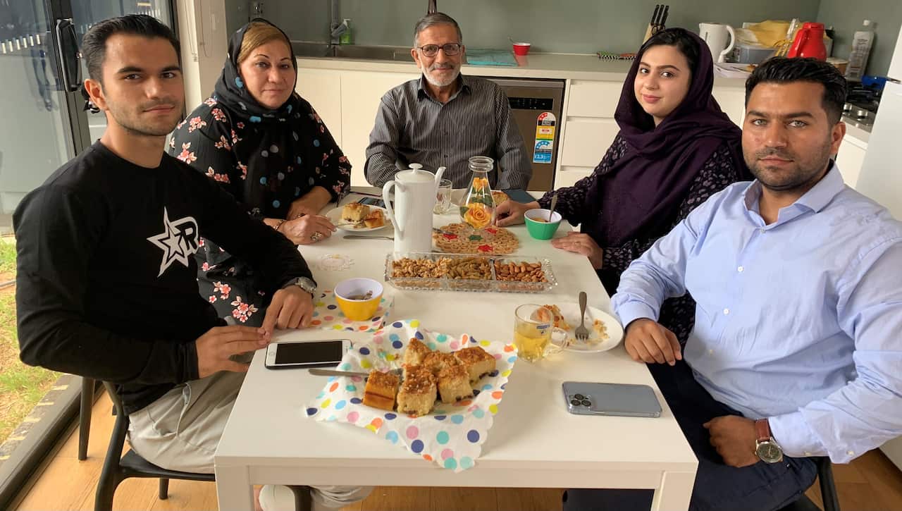 Shigarf family members sitting at a kitchen table 